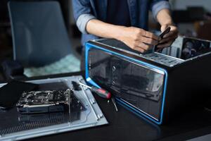 a IT engineer man is working on a computer in a room photo