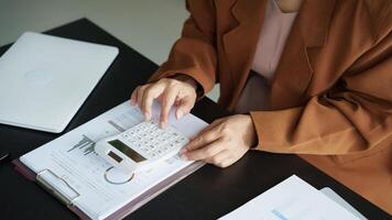 a woman is using a calculator to calculate the amount of money she has photo