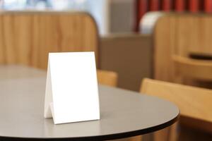 a table with a Menu mock up blank on it sitting in a restaurant photo