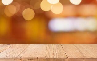 empty wooden table top over blurred bokeh lights background photo