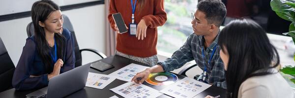 Asian business people Application Designers presenting trending products report mobile application planning process development software design project ux Graphic designer. photo