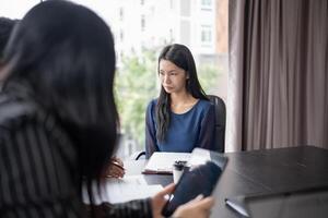 Examiner reading a resume during job interview at office, Business and human resources. photo