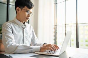 Business man working using laptop computer Hands typing keyboard. Professional investor working start up project. business planning in office, Technology business photo
