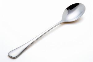 Elegant long handled spoon gleaming silver perfect for dessert or tea Clean white background photo