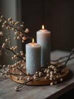 Candles and branches on a wooden table photo