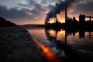 A factory with smoke coming out of the chimney photo