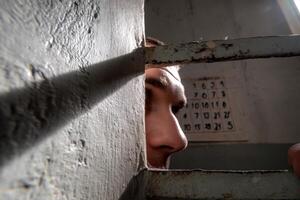 A man peeking through a window photo