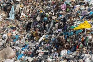Overstuffed landfill disposal area brimming with various waste materials, revealing overconsumption, and global pollution problem photo
