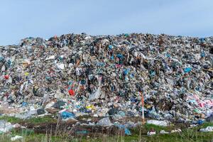 Massive Landfill Heap Full of Mixed Waste, Environmental Pollution Accumulation, Garbage Disposal Site Overflowing with Trash photo