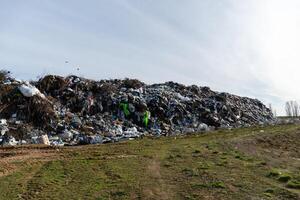 Large Landfill Pile of Trash and Waste Material Against Sky, Indicating Environmental Issues and Pollution Problems photo