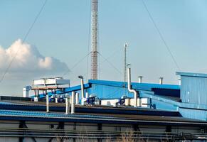 Industrial Building Rooftop with Ventilation System and a Communication Tower photo