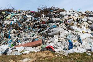 Large piles of plastic and assorted waste dominate the landfill site, cluttering the landscape while drawing attention to the pressing need for sustainable waste management photo