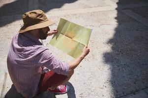 Traveler Exploring a Medieval City with a Map on a Sunny Day photo
