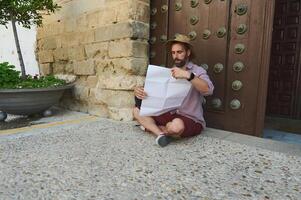 Traveler Exploring a Medieval City While Reading a Map Outdoors photo