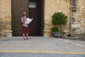 Traveler Exploring Historic Spanish City with a Map in Hand photo
