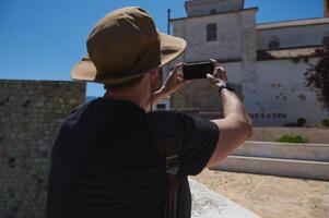 Tourist Captures Historic Architecture on a Sunny Day Exploring a Scenic Location photo