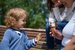 Family Enjoying Ice Cream Together in Bright Park Setting photo