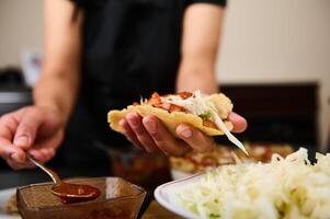 Cook chef, person Preparing Tacos With Fresh Ingredients in a Kitchen Setting photo
