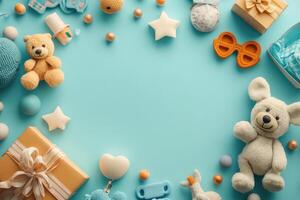 Baby accessories, toys, and gifts arranged on light blue background creating copy space photo