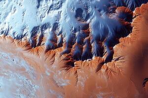 Satellite image showing desert landscape with snow capped mountains photo