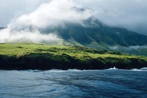Fog rolling over the green cliffs of a tropical island on a cloudy day photo