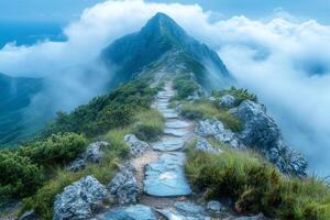 Rocky path leading to a mountain peak surrounded by clouds photo