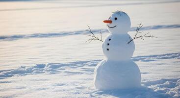Single snowman in bright sunlight on snowy field photo