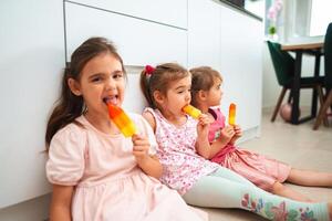 Joyful children enjoying colorful ice pops on a sunny day photo