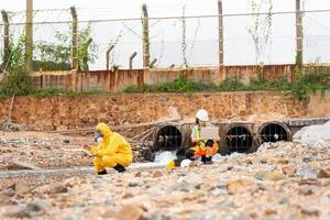 Workers Collecting Water Samples for Environmental Research, Engineers Analyzing Environmental Data on a Beach Cleanup Project, Environmental Engineer Conducting Field Work for Pollution Control photo