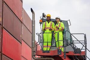 Diverse Team of Engineers Working in Industrial Shipping Yard, Dock Workers Discussing Project on Crane Truck, Foreman Workers Inspecting Cargo Containers at Dockyard photo