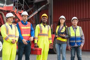 Diverse Industrial Team in Safety Gear at Logistics Hub, Port Workers and Supervisor Standing by Shipping Containers, Frontline Logistics Professionals Ready for Work photo