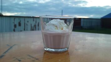 A glass of ice cream with whipped cream on top photo