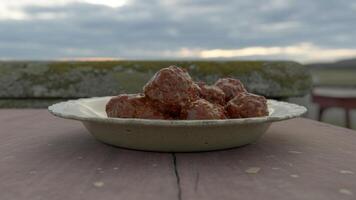 A bowl of meatballs sitting on a table photo