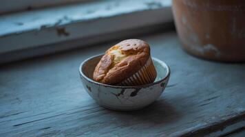 A muffin in a cup on a window sill photo