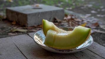 A half eaten melon sitting on a table photo