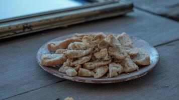 A plate of bread on a table next to a mirror photo