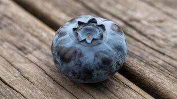A blueberry on a wooden surface photo