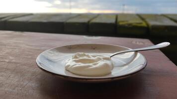 A bowl of yogurt on a table photo