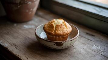 A muffin is sitting in a bowl on a table photo