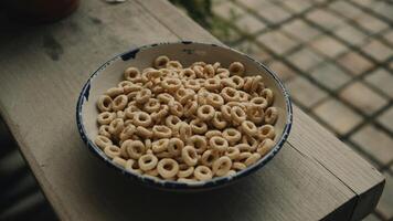 A bowl of cereal on a wooden table photo