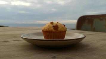 A cupcake sitting on a plate on a table photo