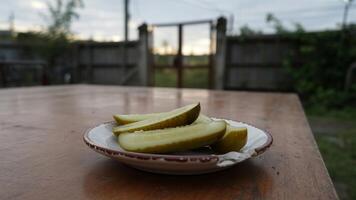 Pickles on a wooden table photo