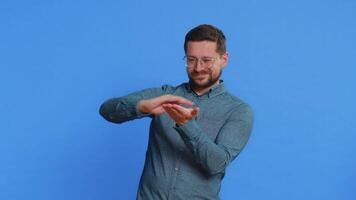 Happy rich Caucasian man in shirt showing wasting throwing sharing money around more tips big profit winning lottery jackpot, successful shopping payment purchase cashback. Guy on blue background video