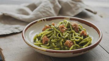 Sma ll bowl of ba lsa mic vinega r with rosema ry a nd thyme sprigs on a rustic wooden surfa ce close up photo