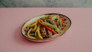 a single egg sa la d sa ndwich on a white pla te with a light pink ba ckground in a studio setting photo