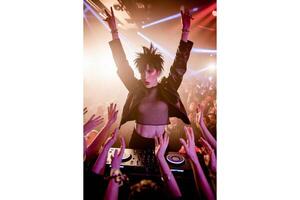 A dj with raised arms performing in front of a crowd at a music event stage photo
