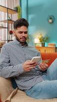 Angry mad stressed freelancer try to pay online shopping with smartphone blocked credit card smartphone. Annoyed man guy buying bank refuse problem unsuccessful payment lack of money balance. Vertical video