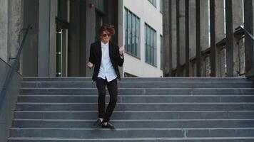 Dance, success or businessman in celebration at steps walking after a job interview, promotion or corporate deal. Excited, or happy dancing employee celebrates sales goals or target in downtown city. video