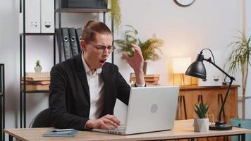 Displeased sad stylish young businessman using laptop notebook typing browsing working loses becoming surprised sudden lottery results bad news fortune loss game fail computer virus. Business people. video