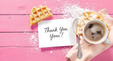 Thank you card with waffles and coffee on pink wooden table photo
